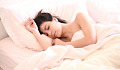 a woman sleeping peacefully in bed